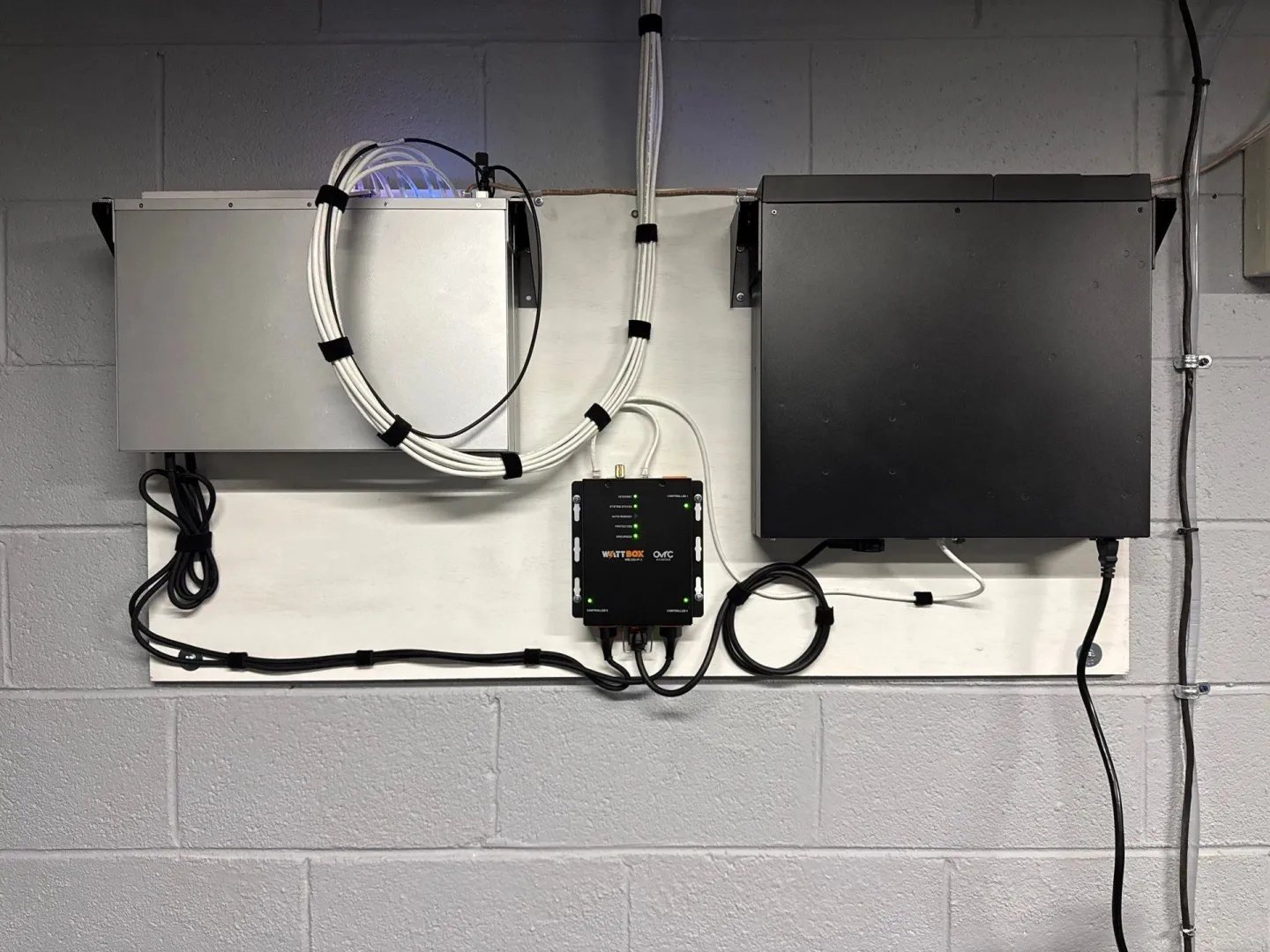 Garage wall with network equipment and a fiber panel mounted on painted block
