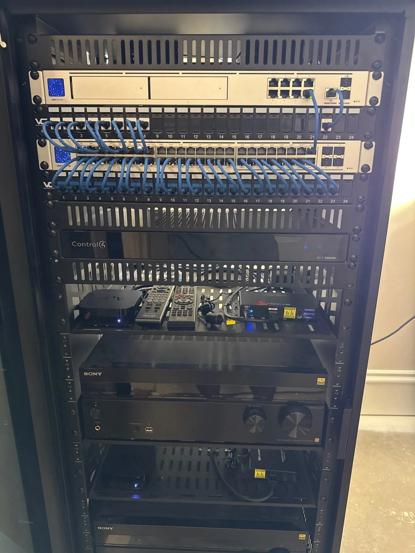 Home network rack with switches, a patch panel and AV equipment