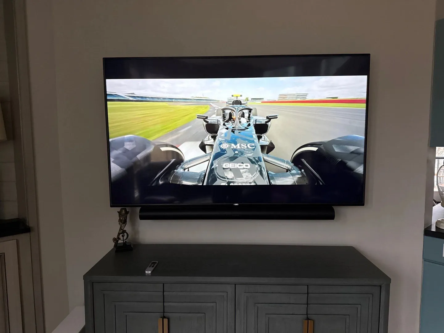 Wall-mounted TV over a gray media console in a living room